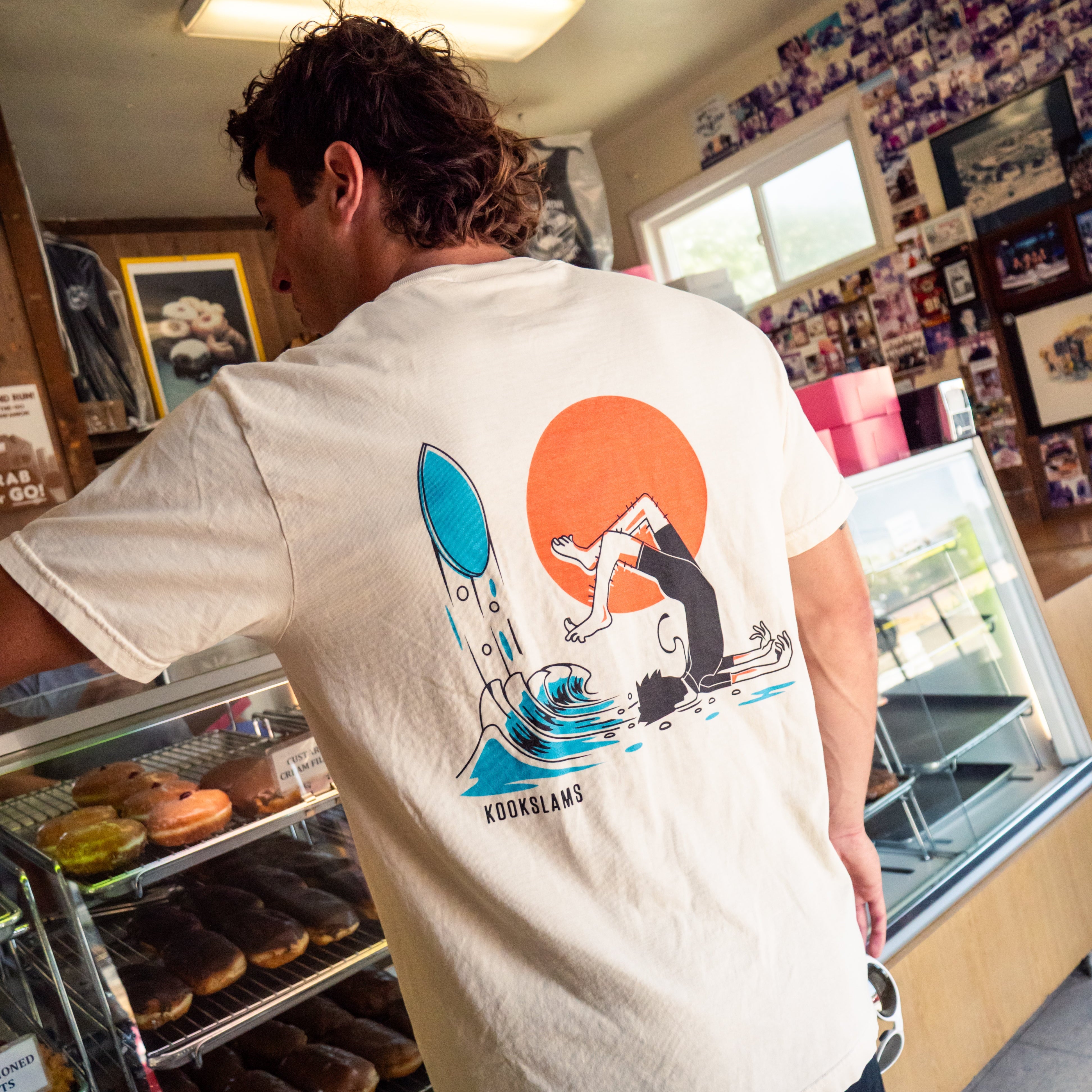 Person wearing a t-shirt with a graphic design in a store setting